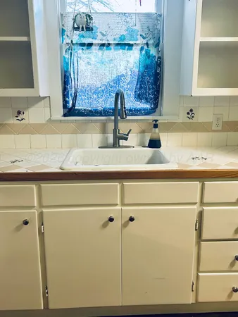 a kitchen with a sink and cabinets