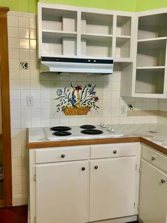 a kitchen with a sink a stove and cabinets