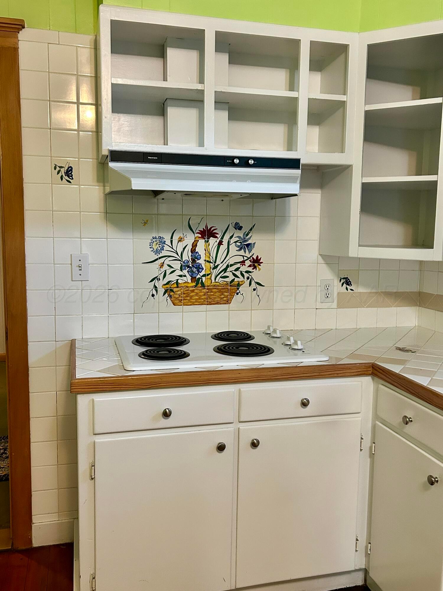1426 South Main Street Canadian, TX 79014 - Photo 14 of 26 a kitchen with a sink a stove and cabinets