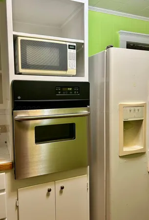 a kitchen with a refrigerator and a stove