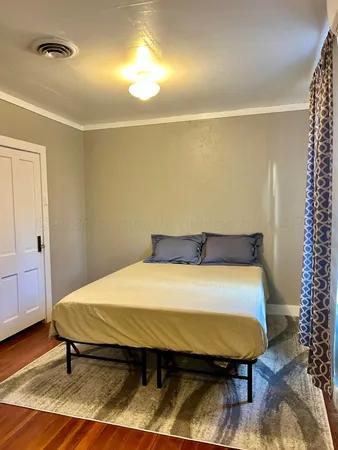 a bed sitting in a room next to a window