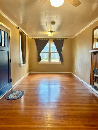 a view of room with window and wooden floor