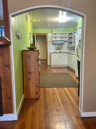 a kitchen with a refrigerator and mirror