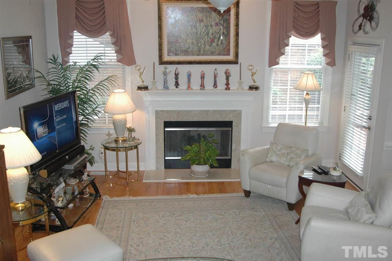7316 Fontana Ridge Lane Raleigh, NC 27613 - Photo 12 of 20 Family room has 10' ceilings, hardwoods, access to the deck/screen porch area
