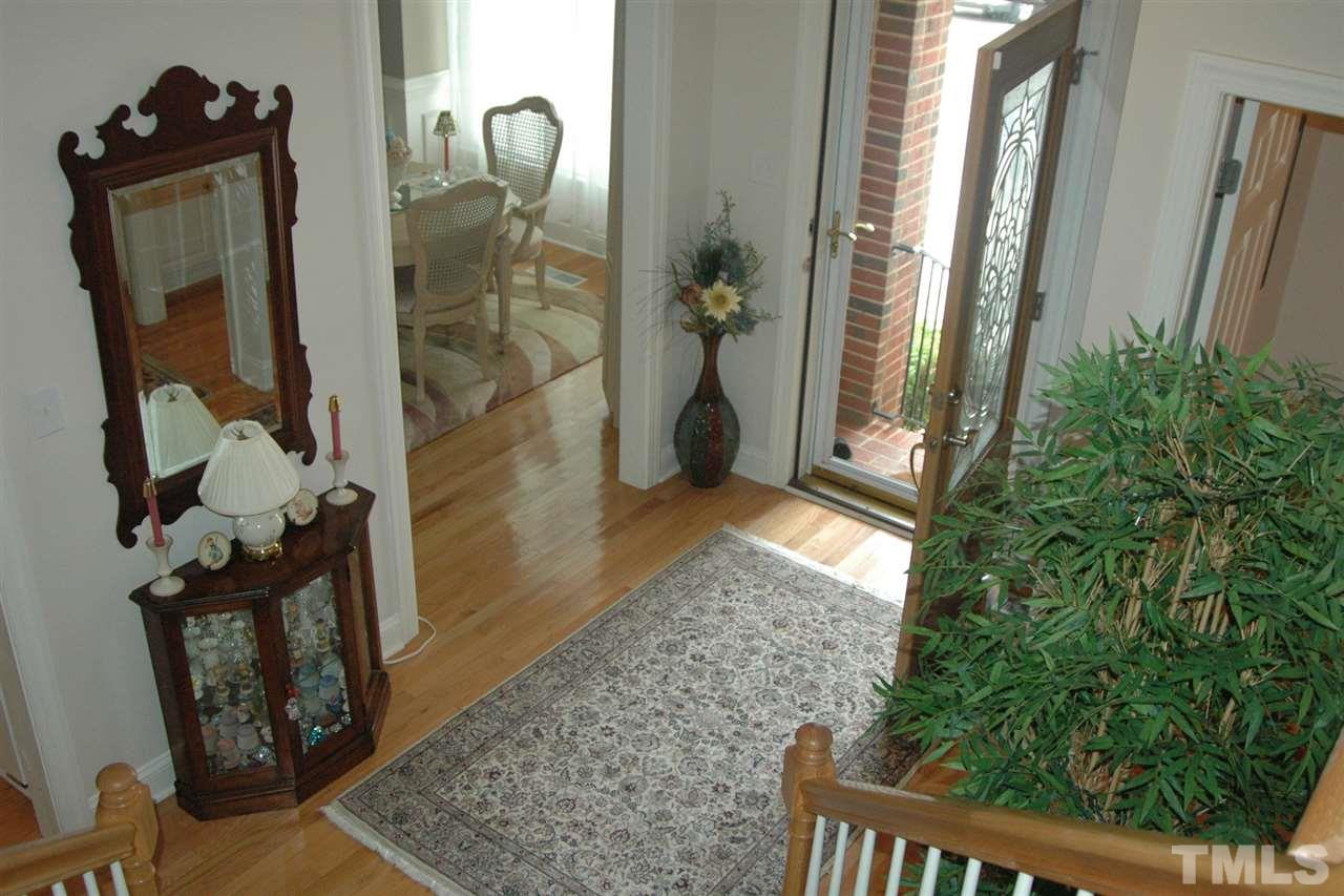 7316 Fontana Ridge Lane Raleigh, NC 27613 - Photo 8 of 20 Entrance foyer is super bright, hardwoods shine like new, seller also added a very nice storm door that she keeps open most of the time