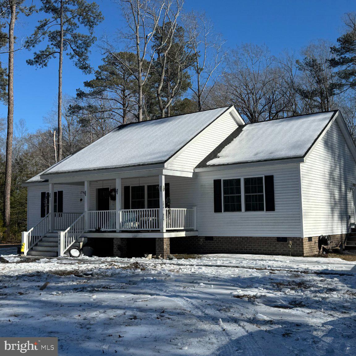 Charming home nestled in snowy woods.