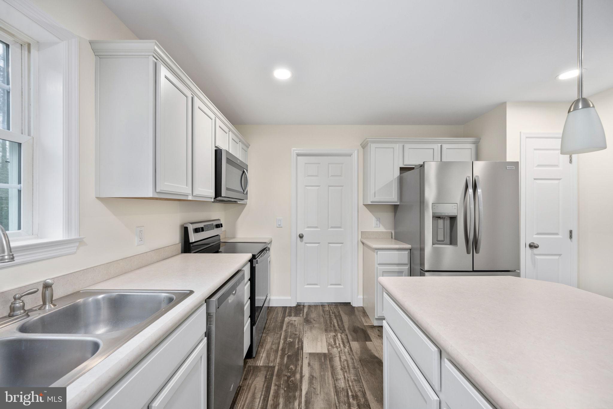 a kitchen with a sink stove and refrigerator