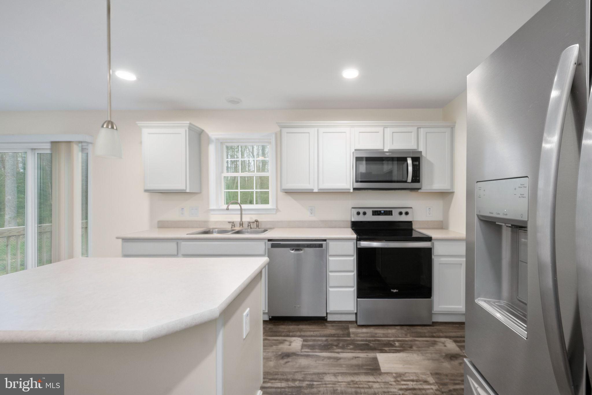 300 River Oaks Road Center Cross, VA 22437 - Photo 22 of 39 a large kitchen with cabinets stainless steel appliances and a counter space