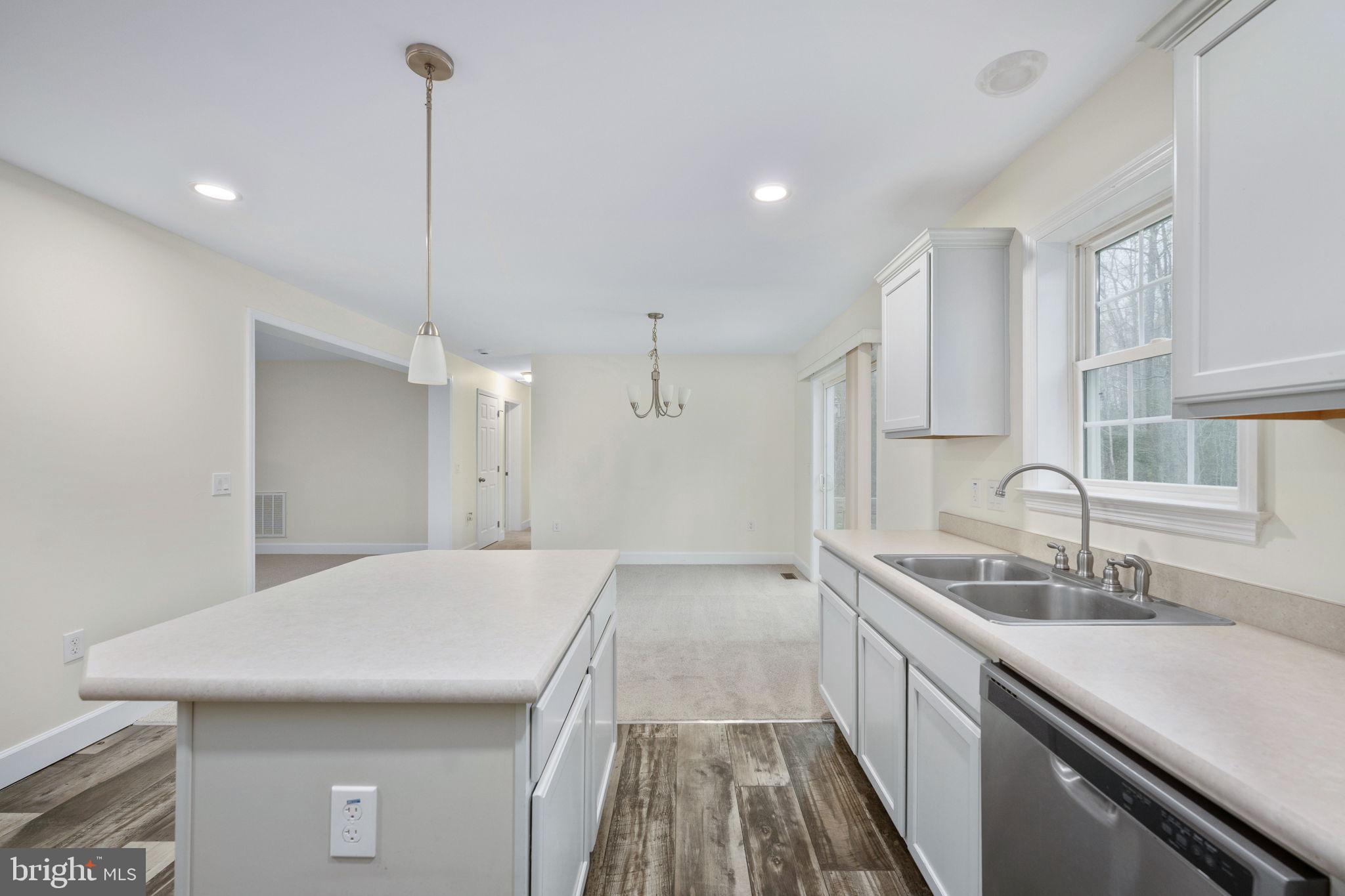 300 River Oaks Road Center Cross, VA 22437 - Photo 23 of 39 a kitchen with a sink a counter space and wooden floor
