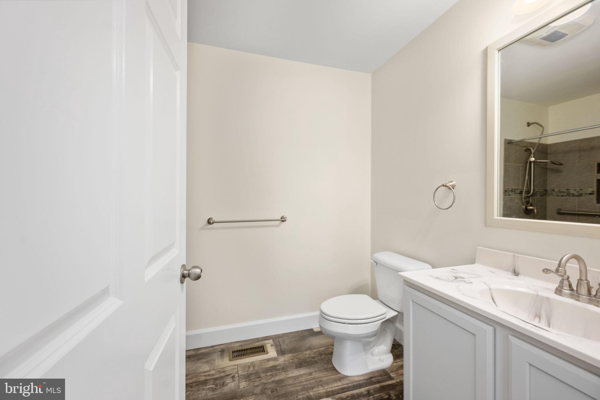 300 River Oaks Road Center Cross, VA 22437 - Photo 29 of 39 a bathroom with a granite countertop sink toilet and shower