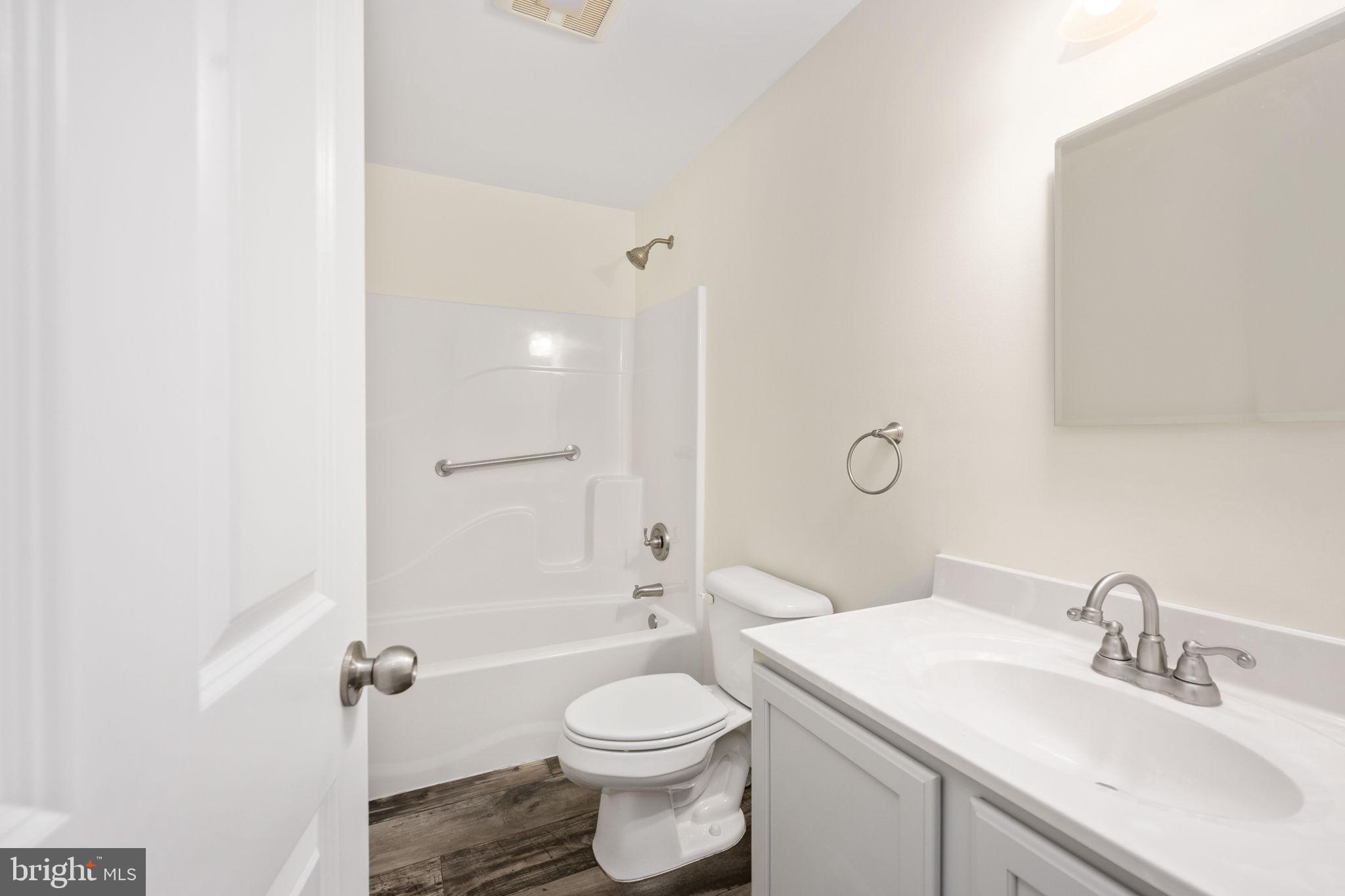 300 River Oaks Road Center Cross, VA 22437 - Photo 32 of 39 a bathroom with a sink toilet vanity and shower
