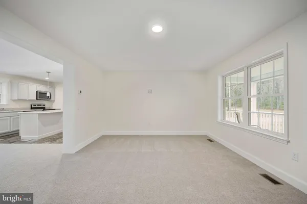 a large kitchen with kitchen island a sink stainless steel appliances and cabinets