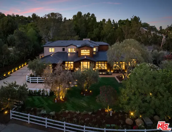 an aerial view of a house with a lake view
