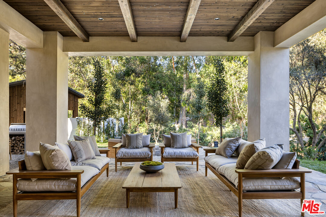 24877 Eldorado Meadow Road Hidden Hills, CA 91302 - Photo 12 of 46 a outdoor living space with furniture and a potted plant