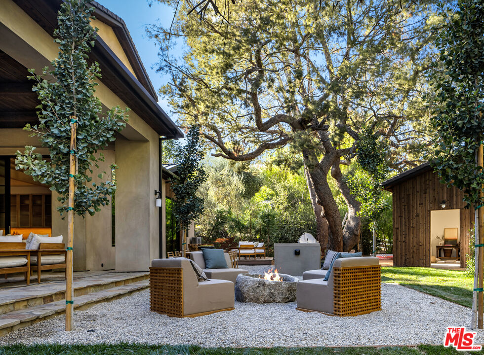 24877 Eldorado Meadow Road Hidden Hills, CA 91302 - Photo 14 of 46 a backyard of a house with table and chairs