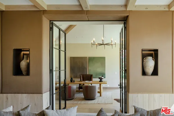 a spacious bedroom with a bed and wooden floor