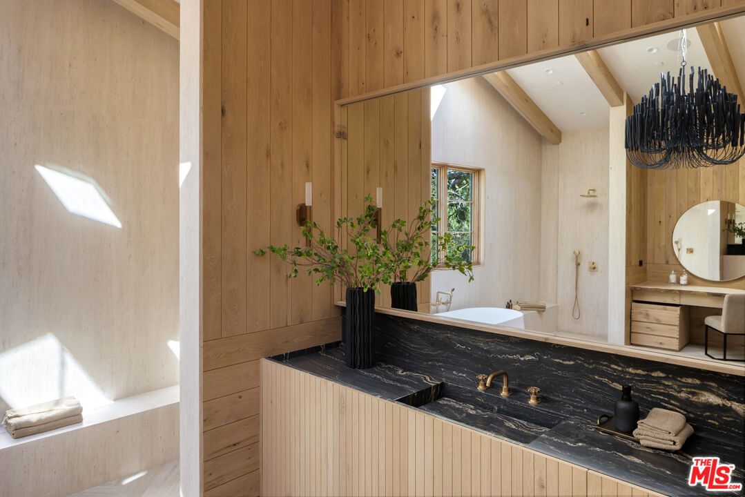 24877 Eldorado Meadow Road Hidden Hills, CA 91302 - Photo 27 of 46 a bathroom with a granite countertop sink and a mirror