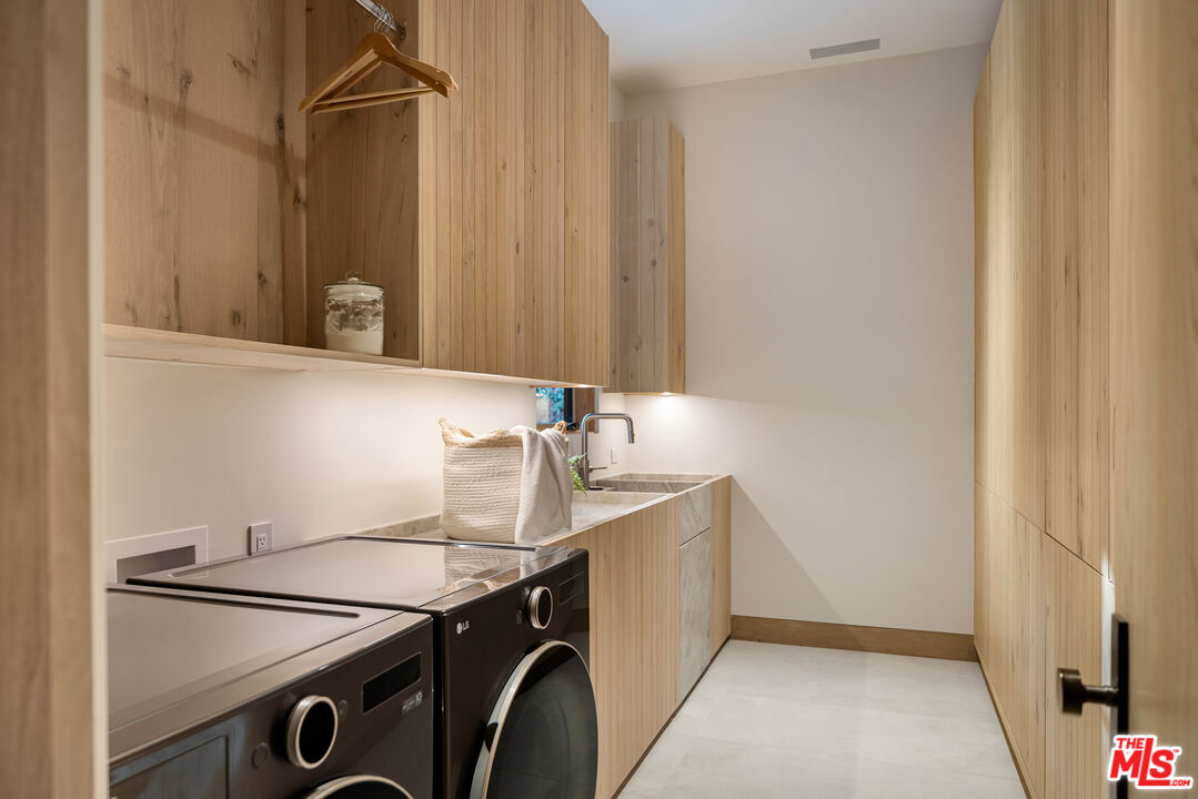 24877 Eldorado Meadow Road Hidden Hills, CA 91302 - Photo 30 of 46 a utility room with dryer and washer