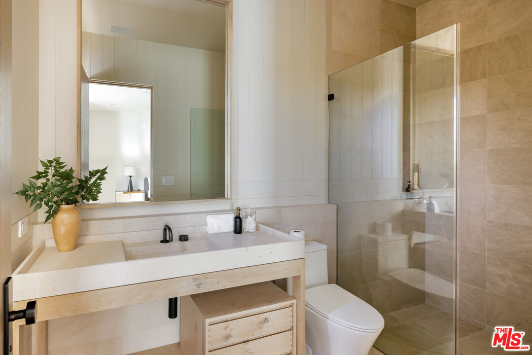 24877 Eldorado Meadow Road Hidden Hills, CA 91302 - Photo 32 of 46 a bathroom with a sink toilet and shower