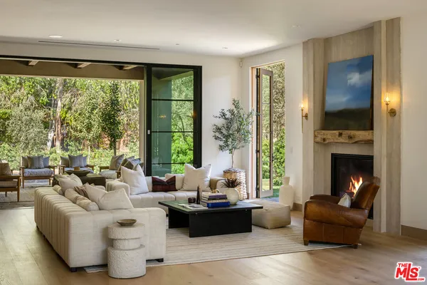 a living room with furniture and a floor to ceiling window