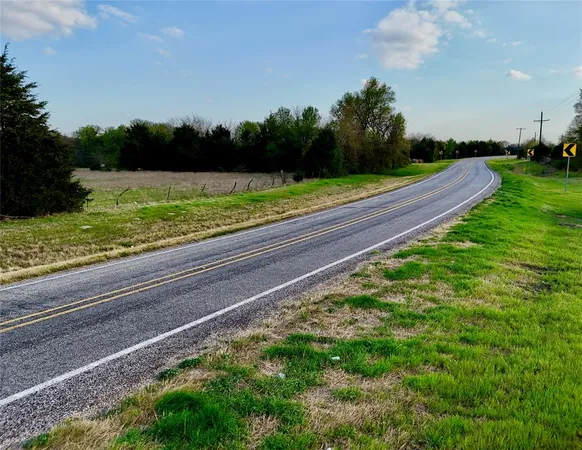 a view of a yard with large trees