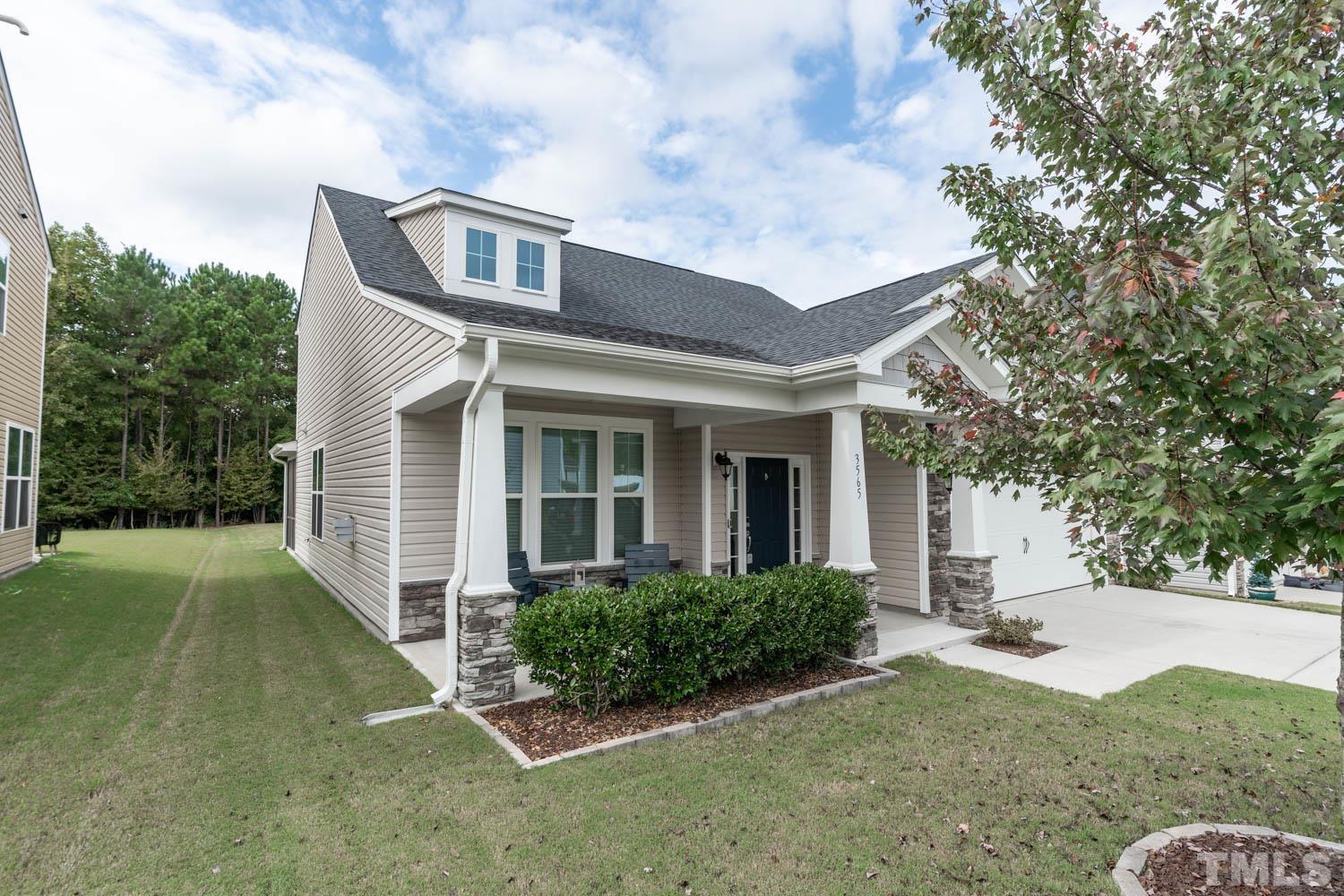 3565 Massey Ridge Court Raleigh, NC 27616 - Photo 2 of 22 a view of a white house next to a yard with plants and trees