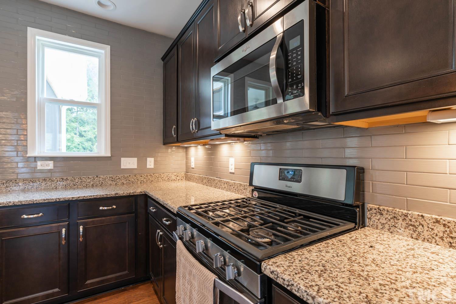 3565 Massey Ridge Court Raleigh, NC 27616 - Photo 11 of 22 a kitchen with stainless steel appliances granite countertop a sink stove and microwave