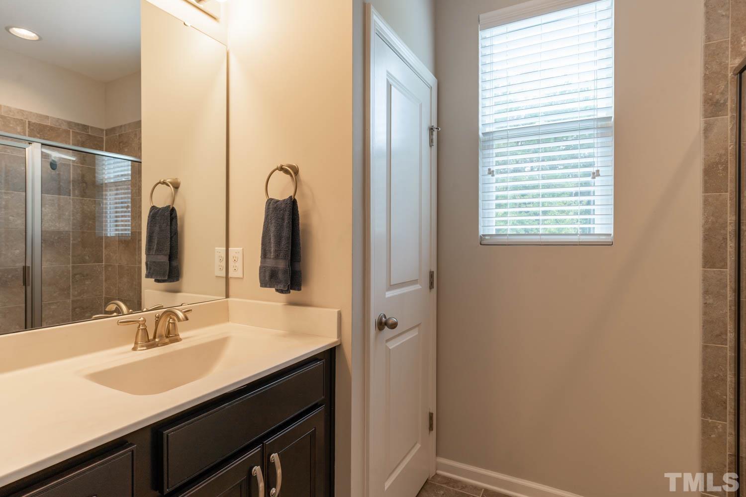 3565 Massey Ridge Court Raleigh, NC 27616 - Photo 15 of 22 a bathroom with a sink and a mirror