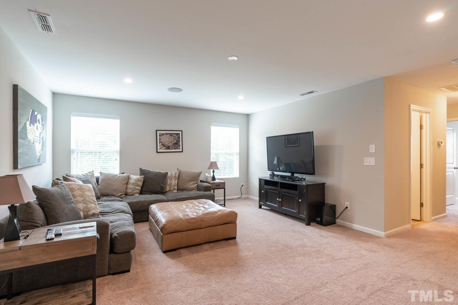 3565 Massey Ridge Court Raleigh, NC 27616 - Photo 16 of 22 a living room with furniture and a flat screen tv