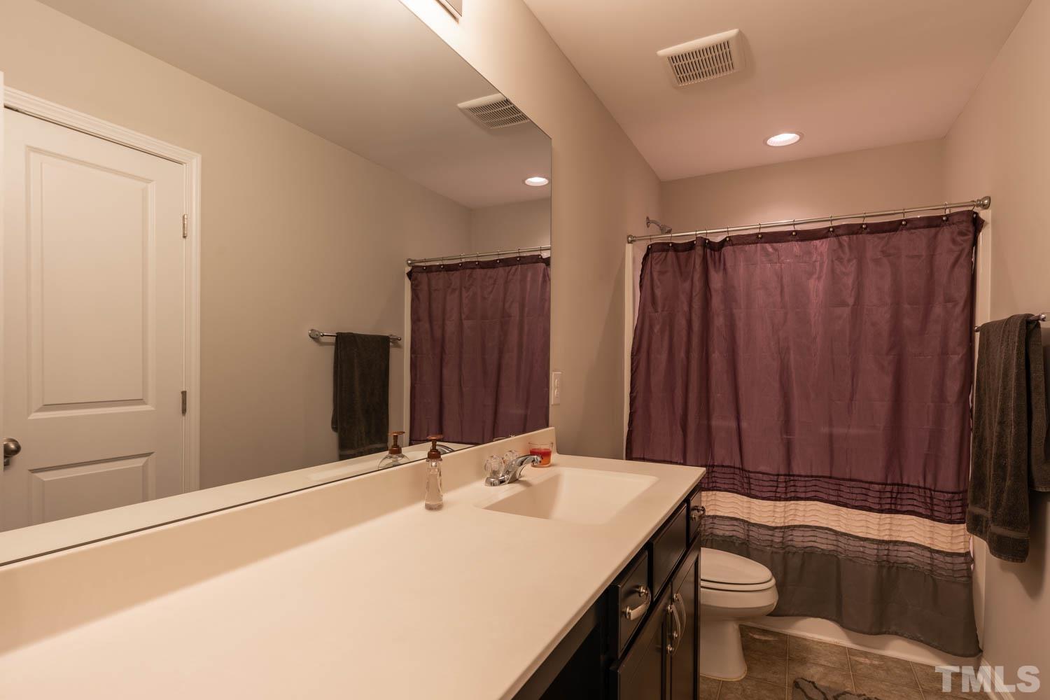 3565 Massey Ridge Court Raleigh, NC 27616 - Photo 18 of 22 a bathroom with a sink and a mirror