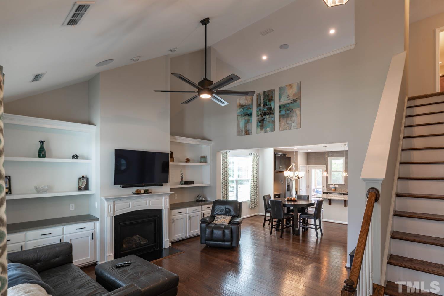3565 Massey Ridge Court Raleigh, NC 27616 - Photo 5 of 22 a living room with furniture a fireplace and a flat screen tv