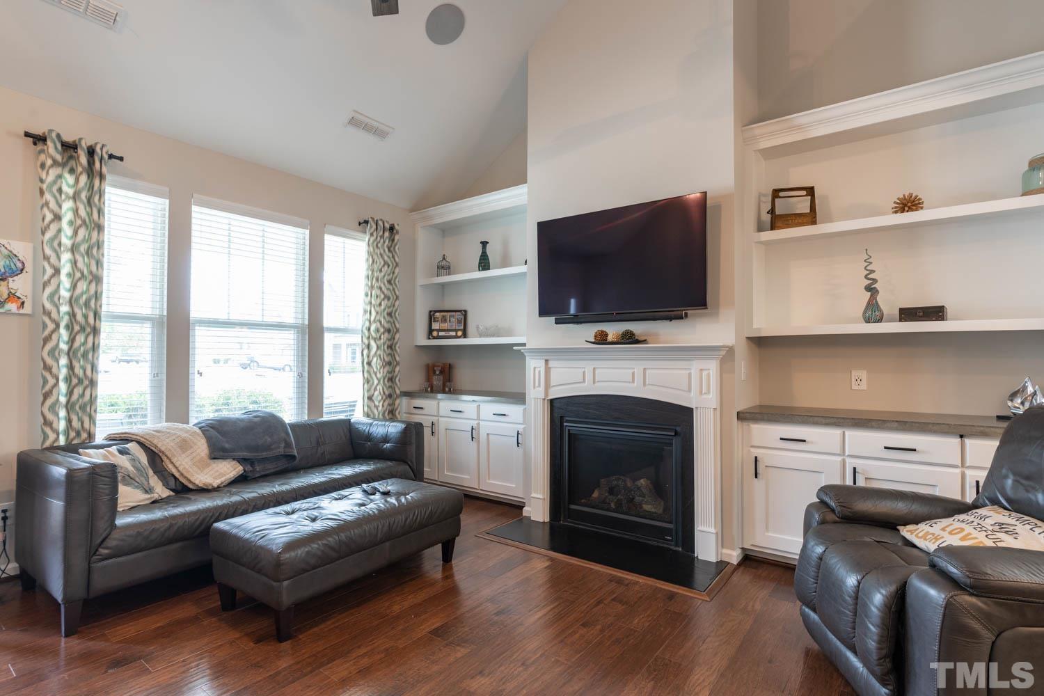 3565 Massey Ridge Court Raleigh, NC 27616 - Photo 7 of 22 a living room with furniture a fireplace and a flat screen tv