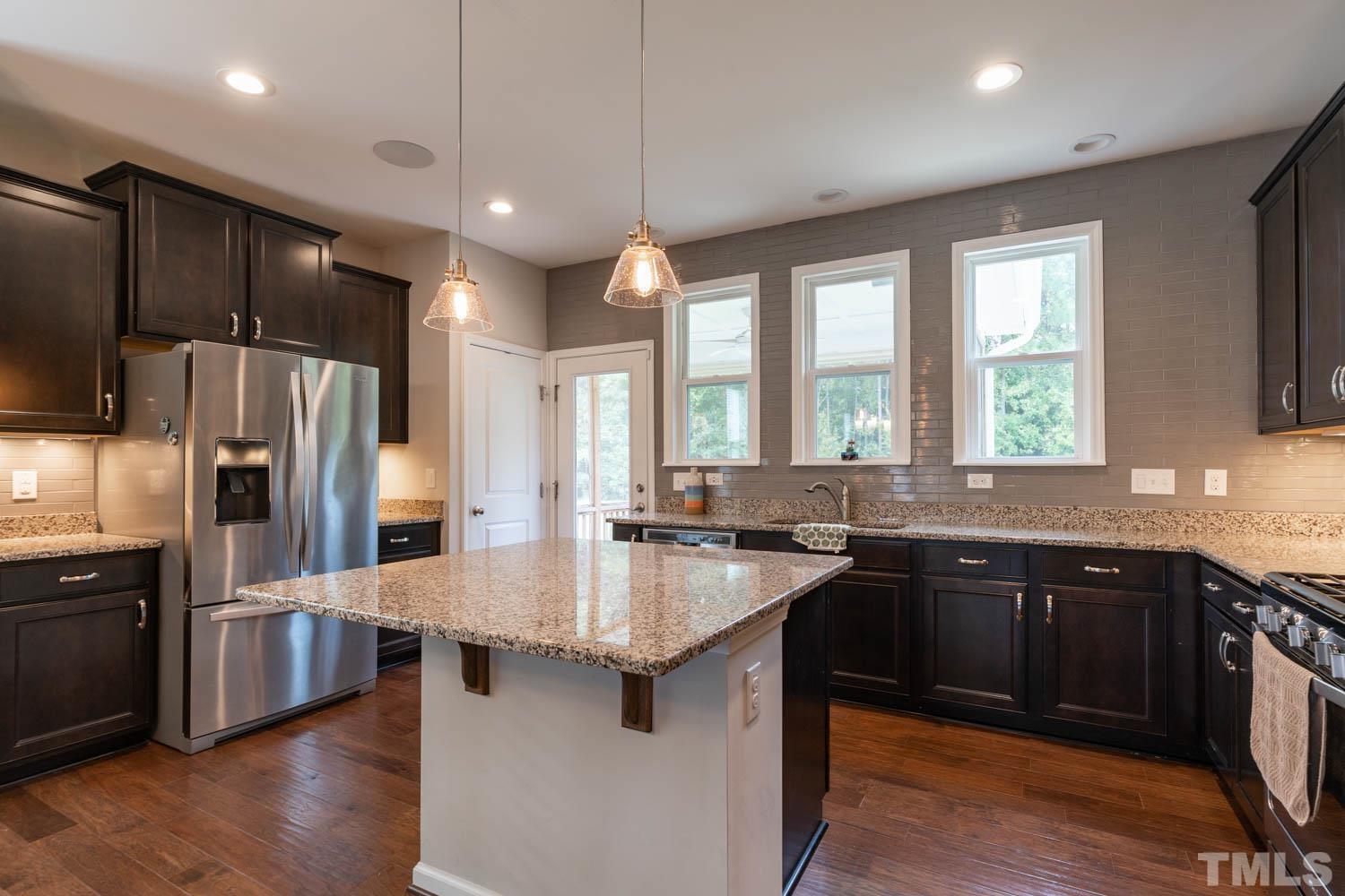 3565 Massey Ridge Court Raleigh, NC 27616 - Photo 10 of 22 a kitchen with lots of counter space a sink appliances and windows