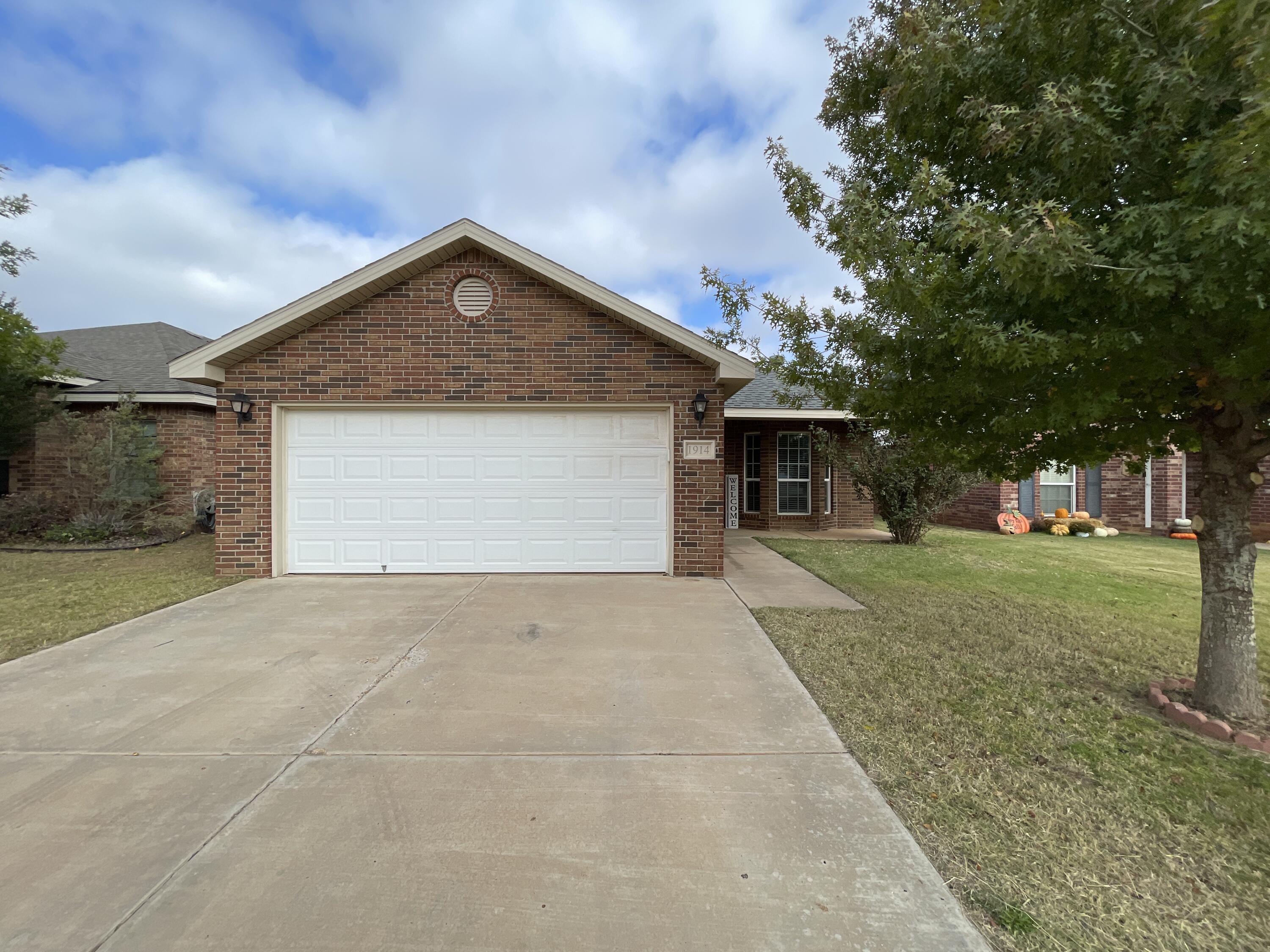 1914 99th Place Lubbock, TX 79423 - Photo 1 of 14 a view of backyard of house and trees