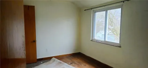 a view of an entryway with wooden floor