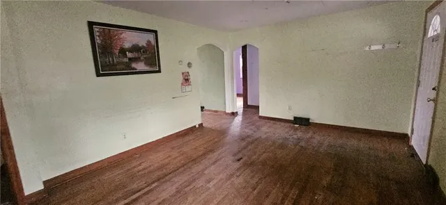 a view of a room with wooden floor and a wall