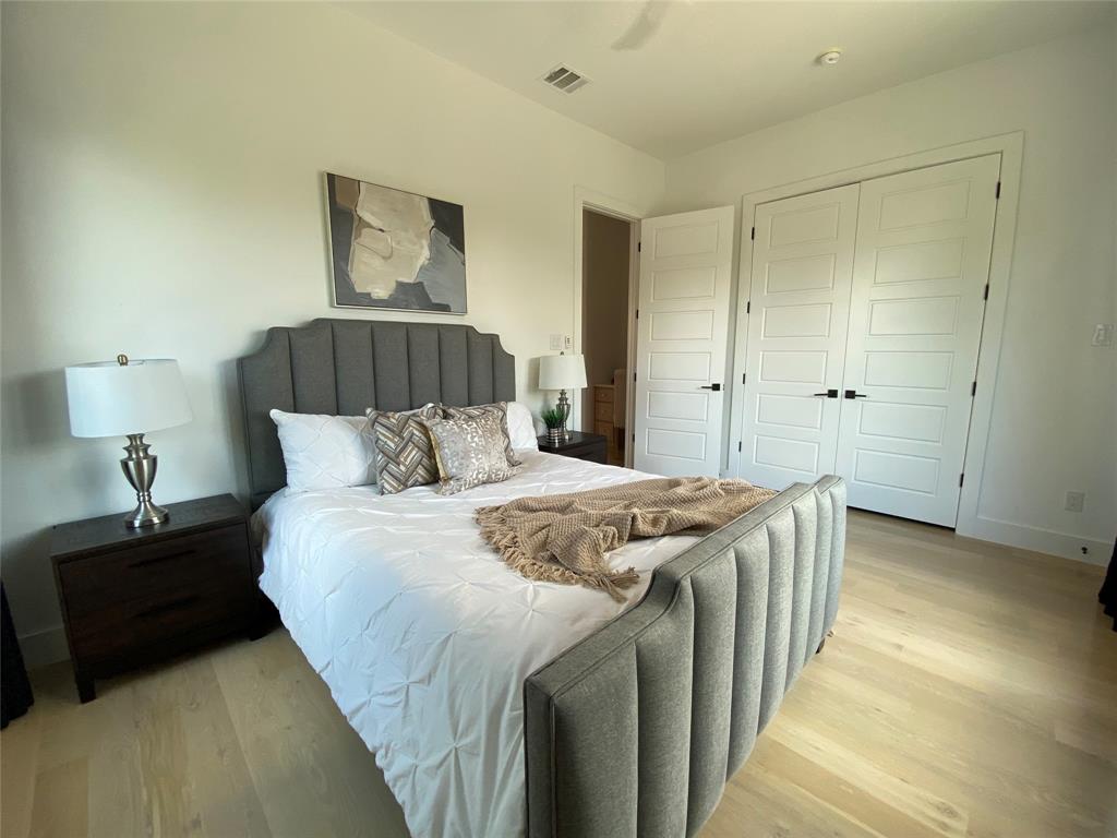 807 South Glasgow Drive Dallas, TX 75223 - Photo 18 of 25 a bedroom with a bed and a lamp