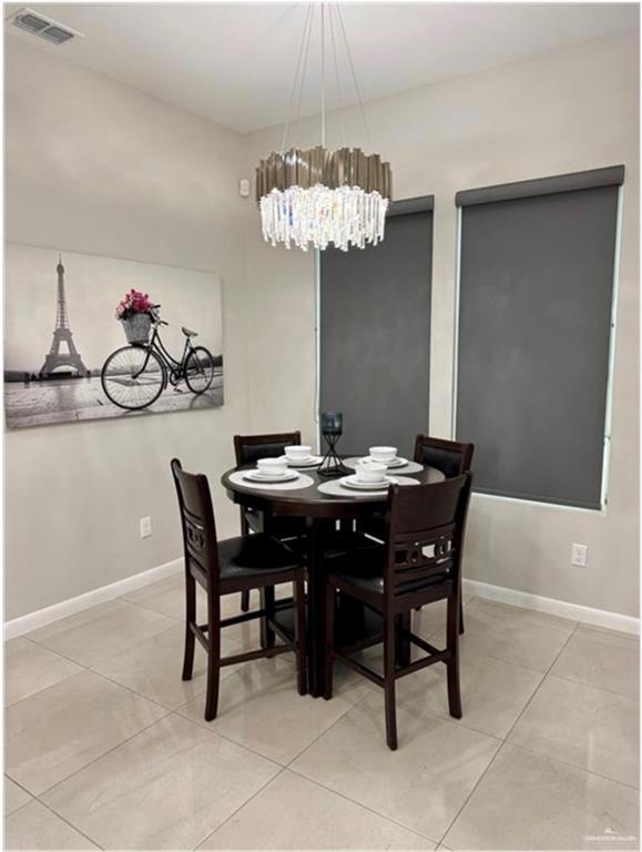 3120 East Rabbit Run Avenue Alton, TX 78573 - Photo 14 of 21 a view of a dining room and a chandelier