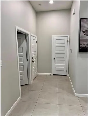 a view of a hallway with closet and cabinet