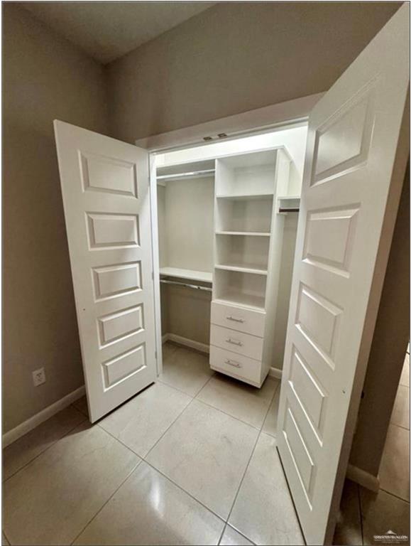 3120 East Rabbit Run Avenue Alton, TX 78573 - Photo 19 of 21 a view of walk in closet with empty racks
