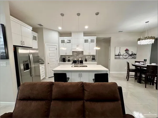 a kitchen with a refrigerator and a dining table