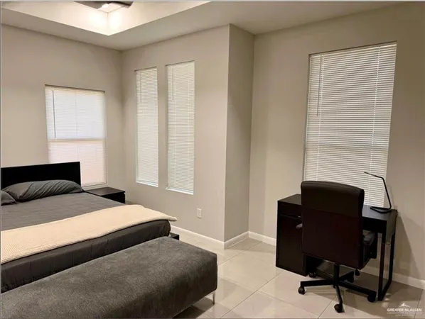 a bedroom with a bed and a windows