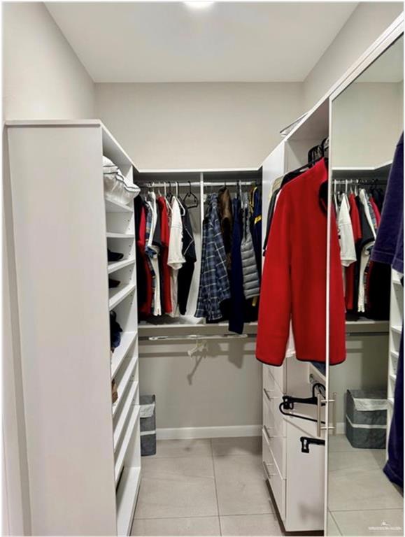 3120 East Rabbit Run Avenue Alton, TX 78573 - Photo 9 of 21 a view of walk in closet with clothes and shoes