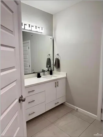 a bathroom with a sink and mirror