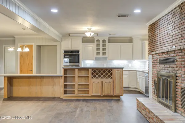 a view of an empty room with wooden floor and closet