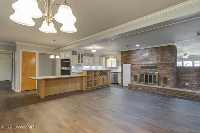 a kitchen with stainless steel appliances a sink stove and cabinets