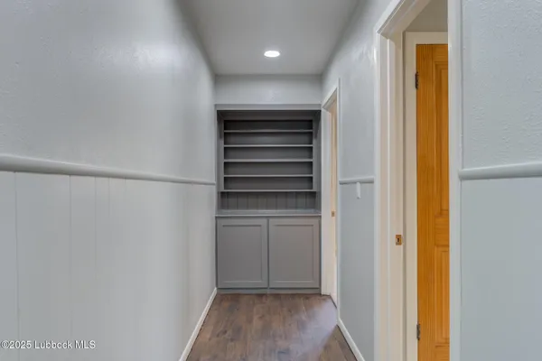 an empty room with a window and a ceiling fan