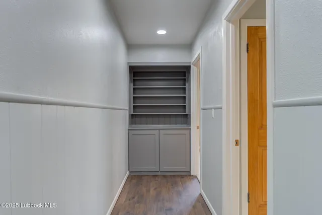 an empty room with a window and a ceiling fan