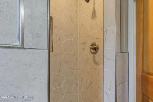 a view of backyard with table and chairs and a large tree