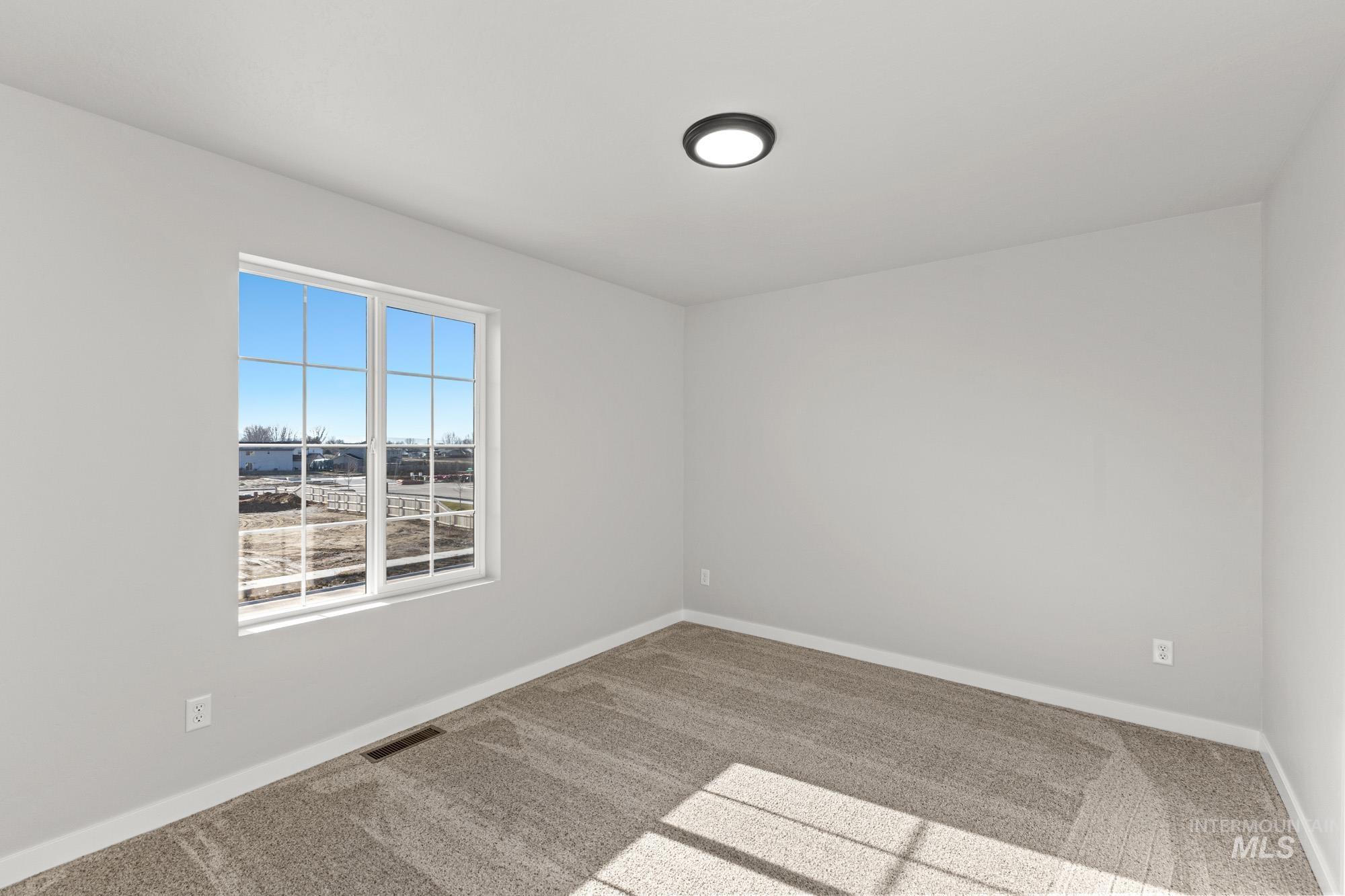 1436 Long Pond Street Middleton, ID 83644 - Photo 12 of 24 Carpeted empty room featuring baseboards